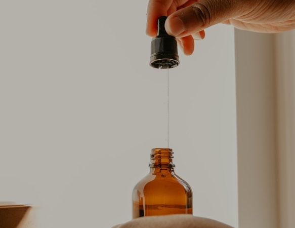 person holding brown glass bottle