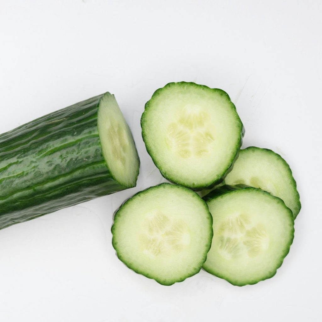 sliced cucumber on white surface