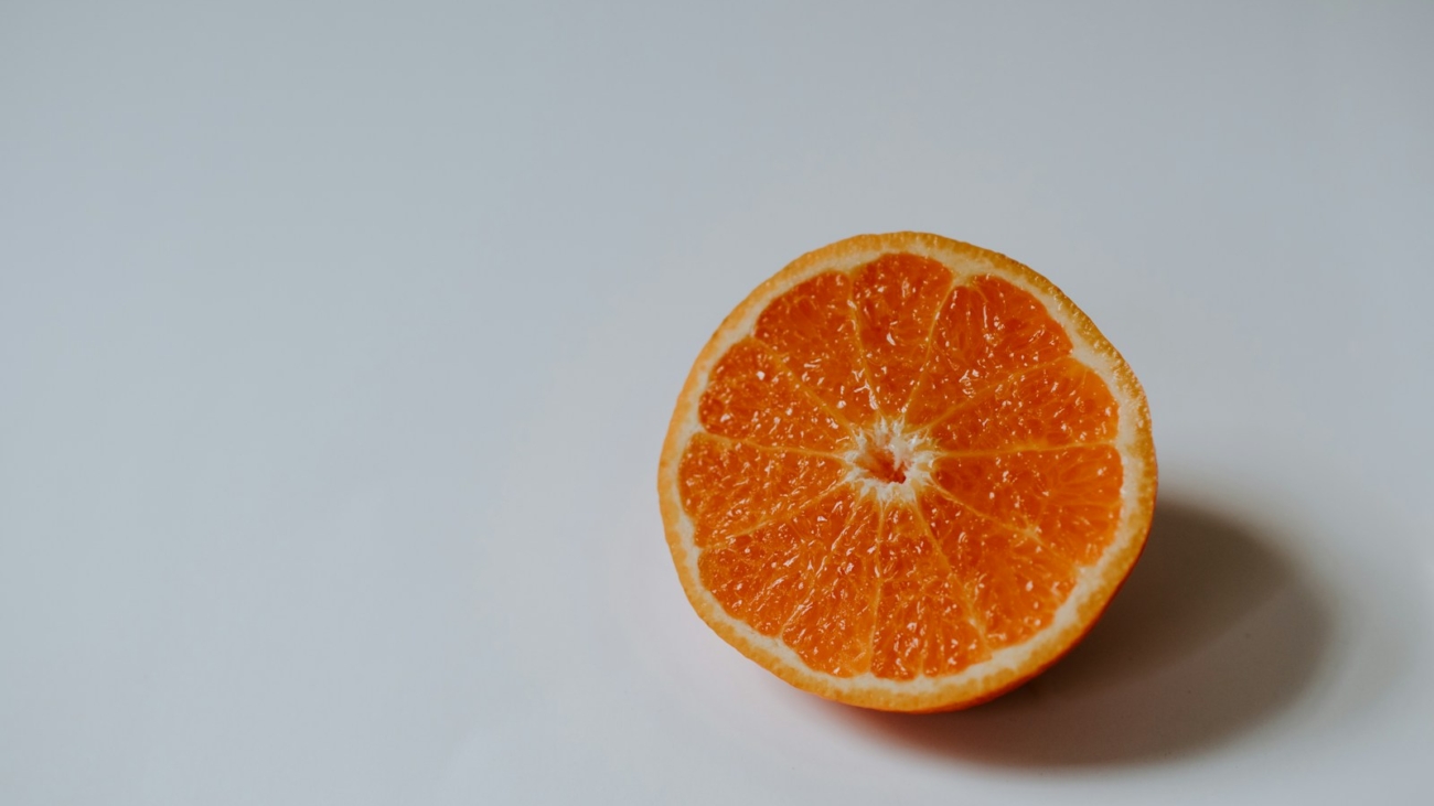 sliced orange fruit on white surface