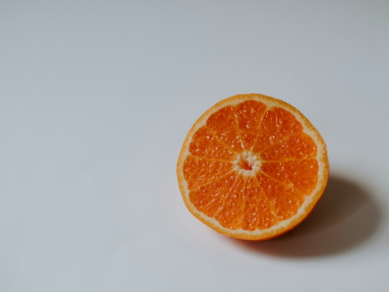 sliced orange fruit on white surface